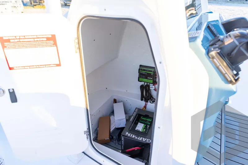 Slide: The Image of 2026 Tidewater 2110 Bay Max boat storage compartment with Garmin equipment and wiring. - 47