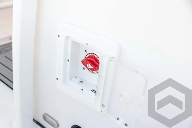 Slide: The Image of 2026 Tidewater 2110 Bay Max boat battery switch, red knob, white panel. - 49