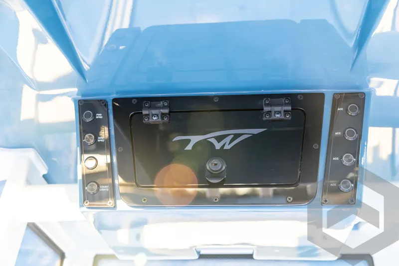 Slide: The Image of 2026 Tidewater 2110 Bay Max boat console with control panel and storage compartment. - 56