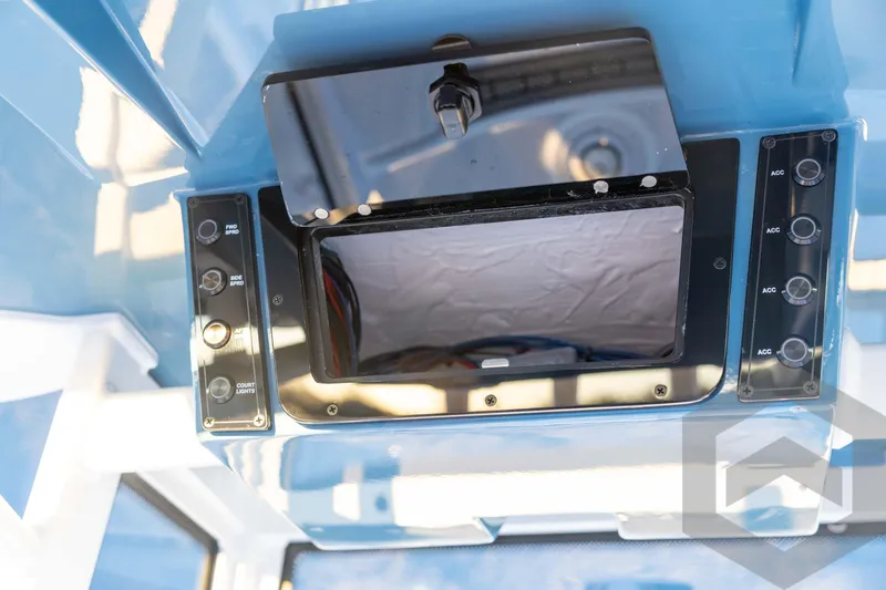 Slide: The Image of 2026 Tidewater 2110 Bay Max boat console with control panel and storage compartment. - 57
