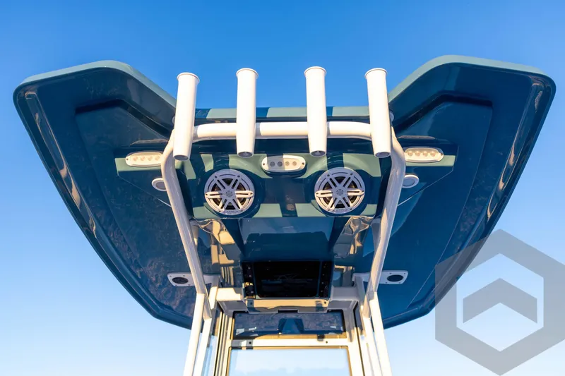 Slide: The Image of 2026 Tidewater 2110 Bay Max boat with T-top and rod holders against blue sky. - 59