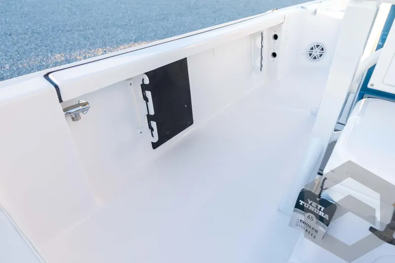 Slide: The Image of 2026 Tidewater 2110 Bay Max boat interior with storage compartment and Yeti cooler. - 64