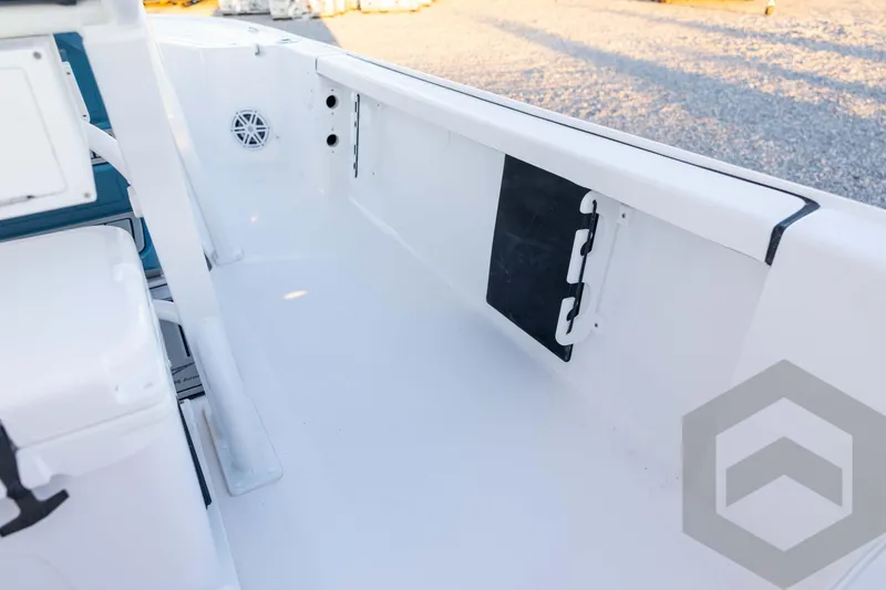 Slide: The Image of 2026 Tidewater 2110 Bay Max boat interior with storage compartment and speaker. - 65