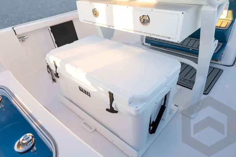 Slide: The Image of 2026 Tidewater 2110 Bay Max boat interior with Yeti cooler and storage compartment. - 67