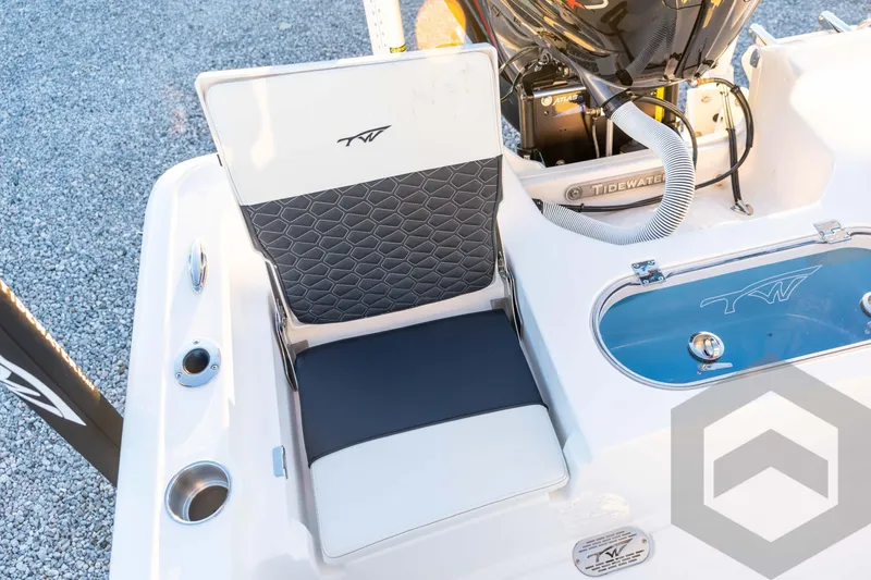 Slide: The Image of 2026 Tidewater 2110 Bay Max boat interior with cushioned seating and engine details. - 69
