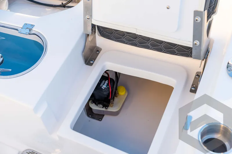 Slide: The Image of 2026 Tidewater 2110 Bay Max boat storage compartment with battery and wiring. - 71