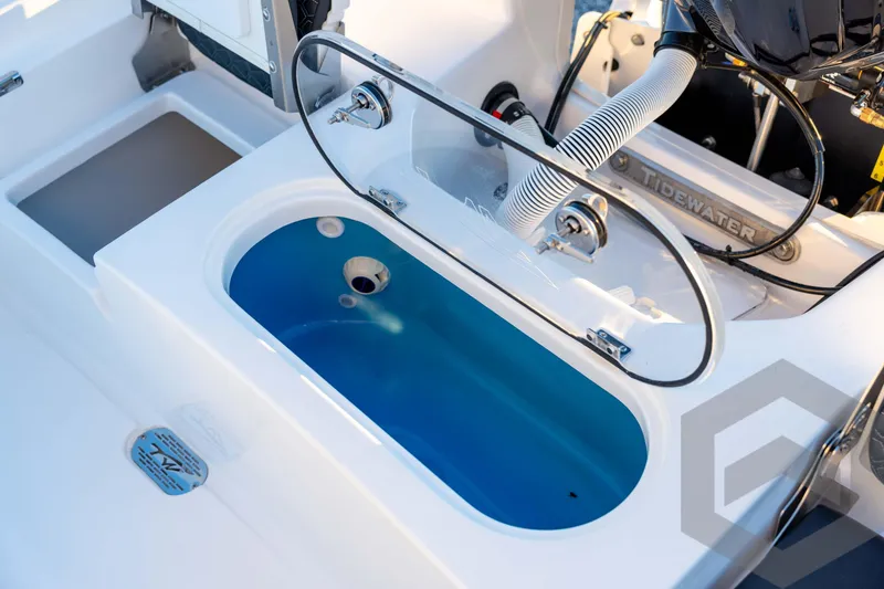 Slide: The Image of 2026 Tidewater 2110 Bay Max boat with open livewell and visible engine components. - 72