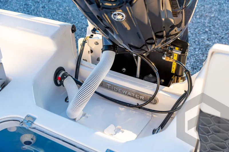 Slide: The Image of 2026 Tidewater 2110 Bay Max boat engine compartment with visible hoses and fittings. - 73