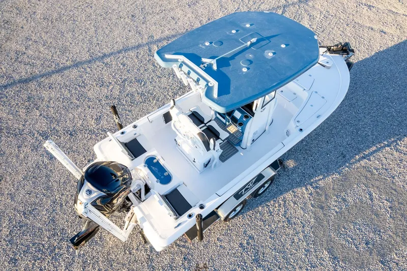 Slide: The Image of 2026 Tidewater 2110 Bay Max boat on trailer, aerial view, blue and white design. - 83