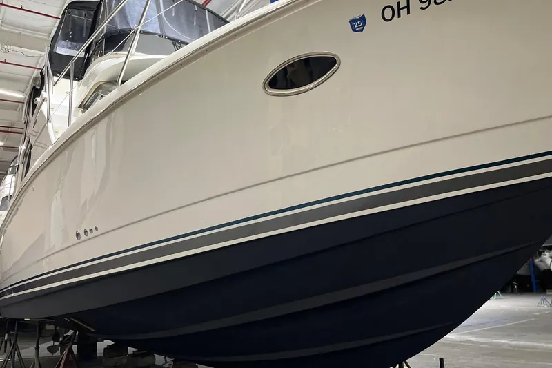 Slide: The Image of 1998 Silverton 352 Motor Yacht in storage, showcasing sleek design and white hull. - 2