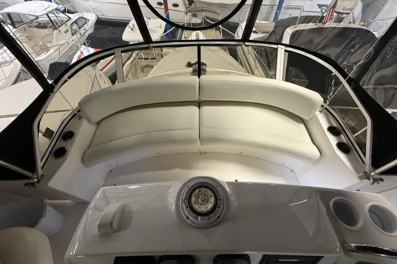 Slide: The Image of 1998 Silverton 352 Motor Yacht interior with white seating and helm controls. - 20