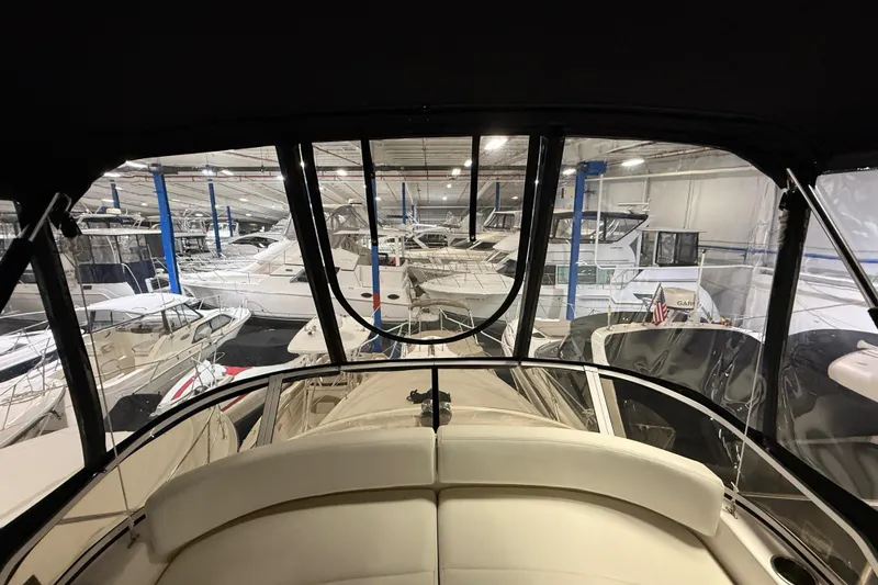 Slide: The Image of 1998 Silverton 352 Motor Yacht in indoor marina, surrounded by other boats. - 21