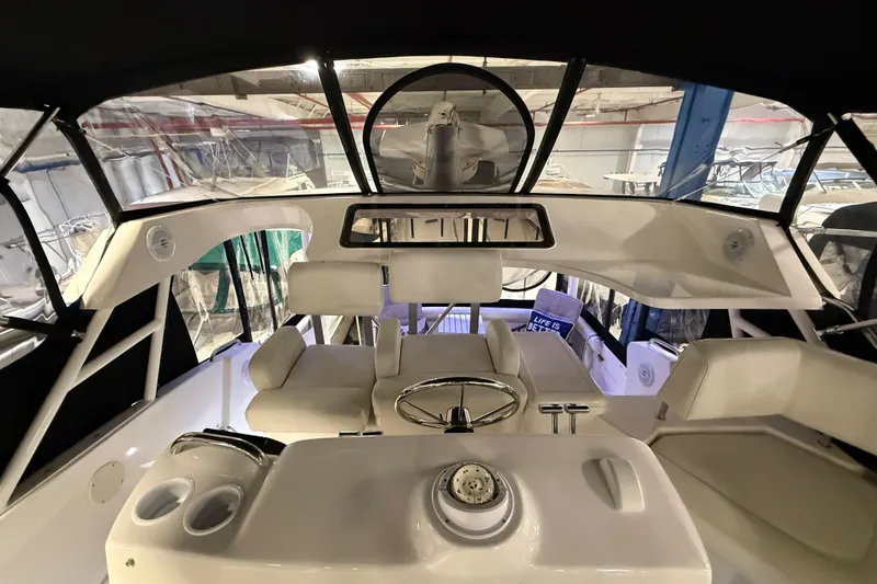 Slide: The Image of 1998 Silverton 352 Motor Yacht interior with helm, seating, and panoramic windows. - 22