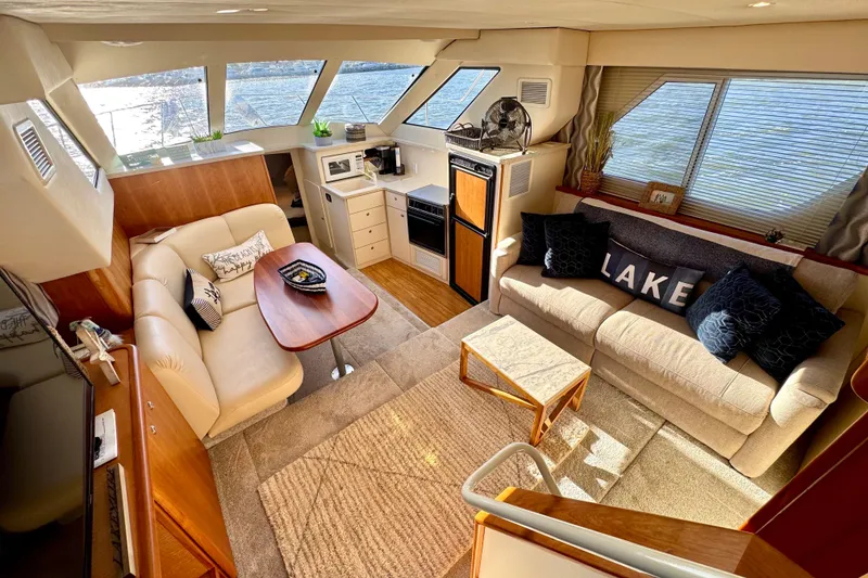 Slide: The Image of Luxurious interior of a 1998 Silverton 352 Motor Yacht with cozy seating and modern amenities. - 24