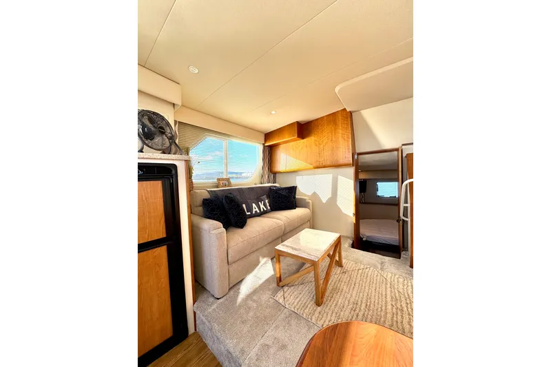 Slide: The Image of Interior of 1998 Silverton 352 Motor Yacht with cozy seating and natural light. - 28