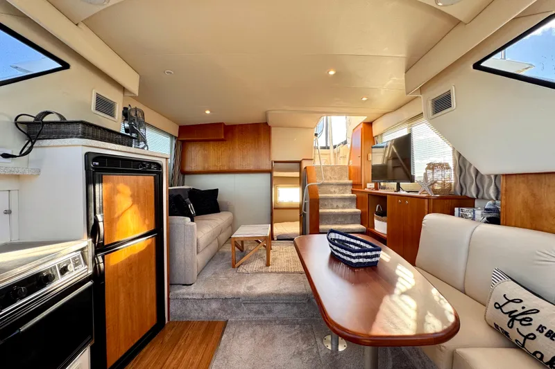 Slide: The Image of Interior of a 1998 Silverton 352 Motor Yacht, featuring cozy seating and modern amenities. - 29