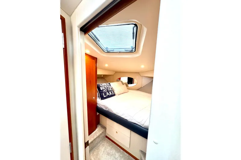 Slide: The Image of 1998 Silverton 352 Motor Yacht cabin with skylight and cozy bedding. - 31