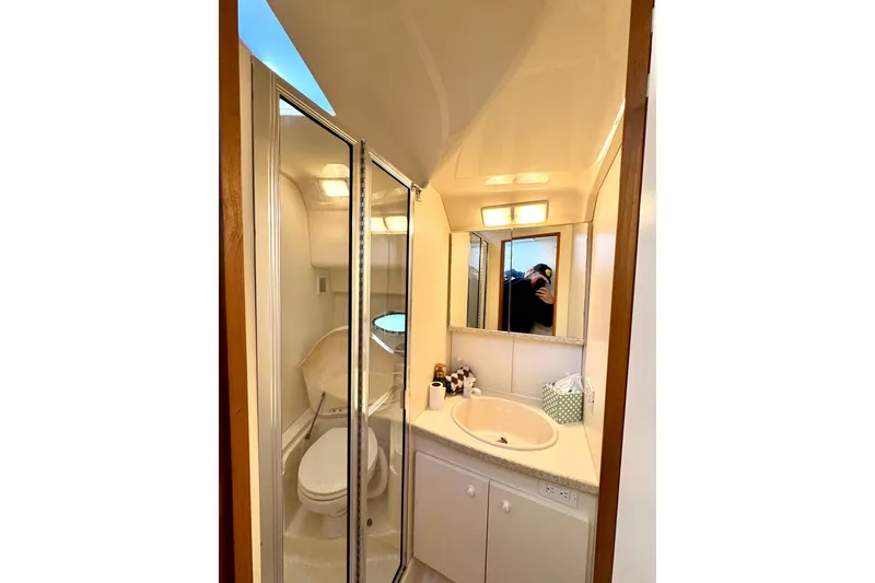 Slide: The Image of 1998 Silverton 352 Motor Yacht bathroom with shower, sink, and mirror. - 34