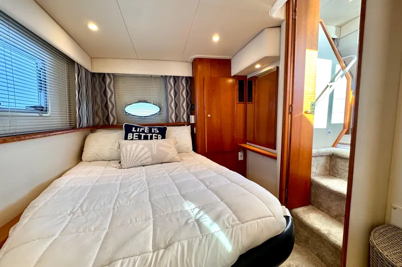 Slide: The Image of Cozy bedroom in 1998 Silverton 352 Motor Yacht with plush bedding and wooden accents. - 37