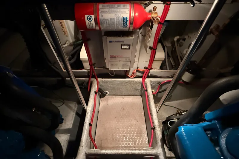Slide: The Image of Engine room of 1998 Silverton 352 Motor Yacht with fire extinguisher and wiring. - 40