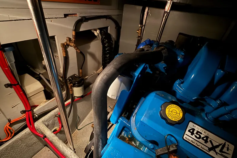 Slide: The Image of Engine room of a 1998 Silverton 352 Motor Yacht with visible blue engine components. - 42