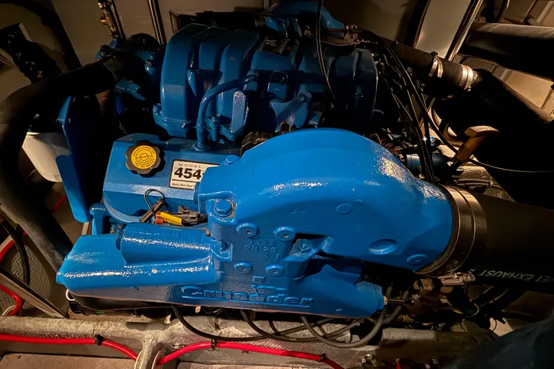 Slide: The Image of Blue engine of a 1998 Silverton 352 Motor Yacht, model 454, in a dimly lit compartment. - 43