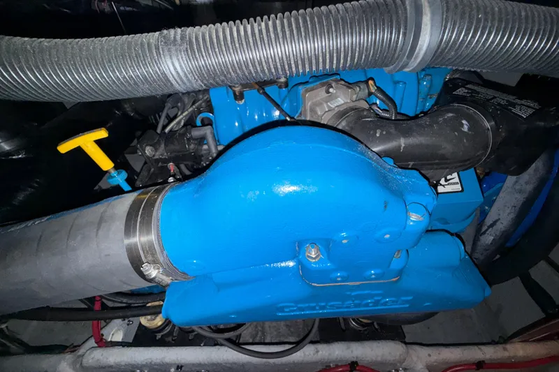 Slide: The Image of Engine compartment of a 1998 Silverton 352 Motor Yacht, featuring blue components and hoses. - 44