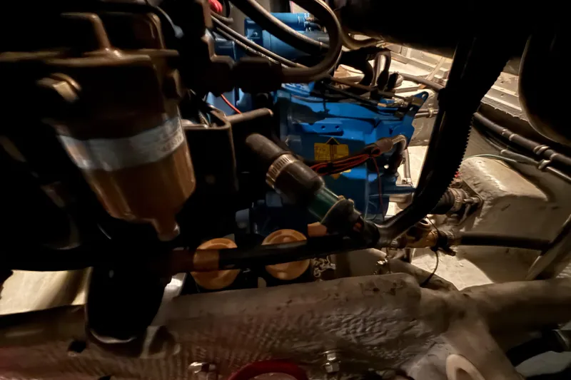 Slide: The Image of Engine room of 1998 Silverton 352 Motor Yacht, showcasing mechanical components and wiring. - 46