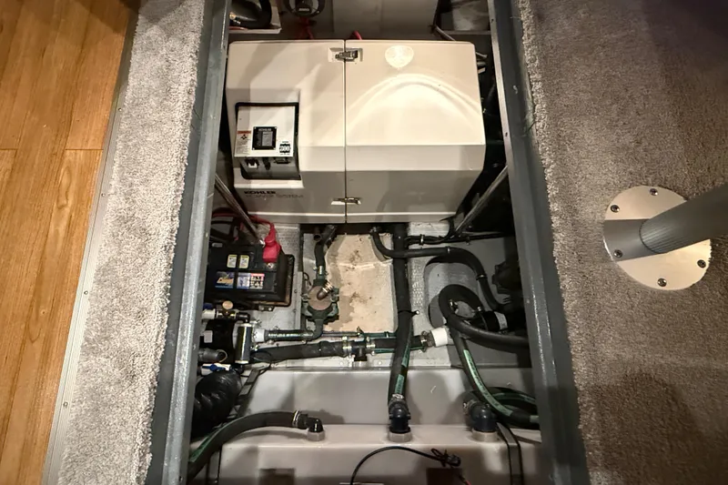 Slide: The Image of Engine compartment of a 1998 Silverton 352 Motor Yacht, showcasing generator and wiring. - 50