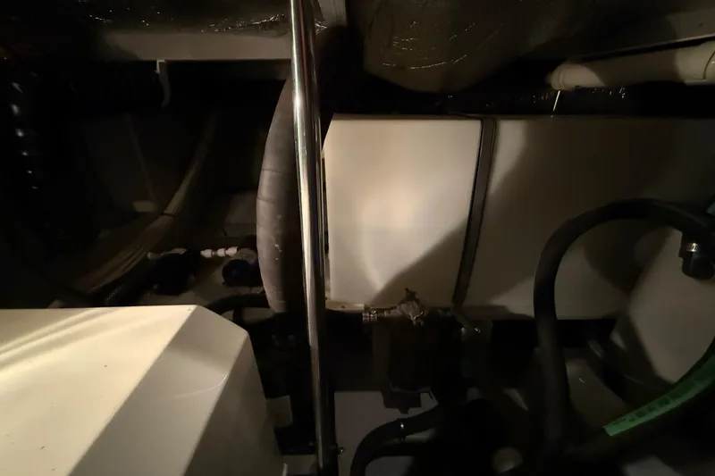 Slide: The Image of 1998 Silverton 352 Motor Yacht engine room with pipes and equipment. - 54