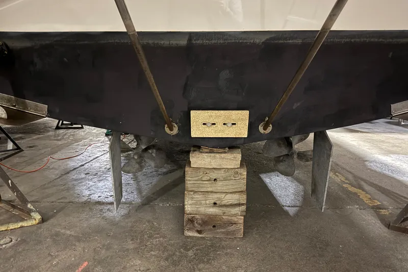 Slide: The Image of 1998 Silverton 352 Motor Yacht hull on wooden blocks in a workshop. - 57