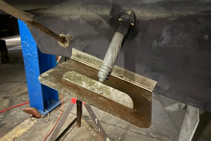 Slide: The Image of Close-up of a 1998 Silverton 352 Motor Yacht trim tab in a workshop. - 58