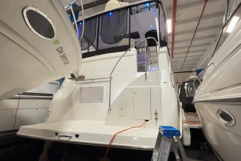 Slide: The Image of 1998 Silverton 352 Motor Yacht in storage, rear view with ladder access. - 8