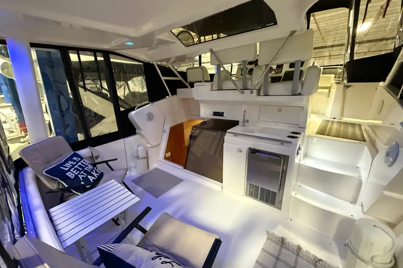 Slide: The Image of 1998 Silverton 352 Motor Yacht interior with seating, kitchenette, and modern amenities. - 9
