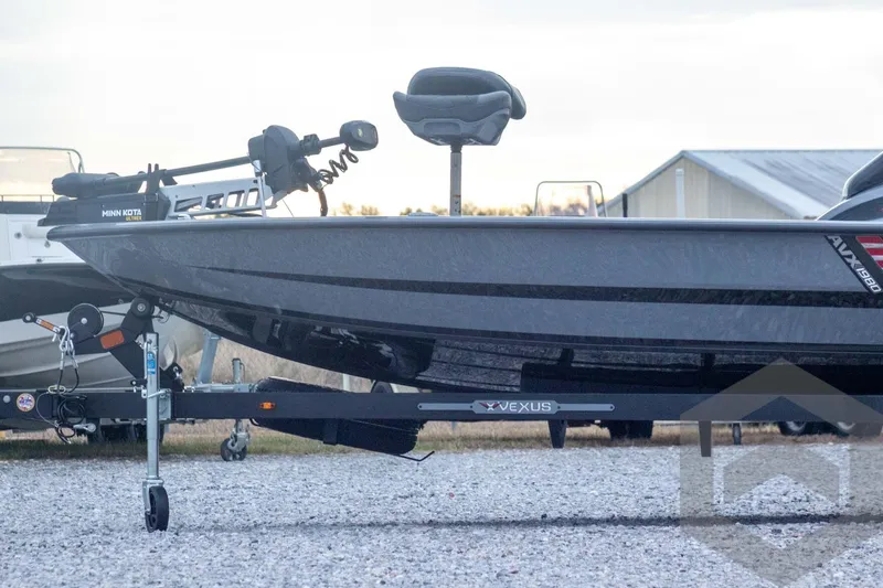 Slide: The Image of 2026 Vexus AVX 1980 boat on trailer, featuring Minn Kota trolling motor. - 14