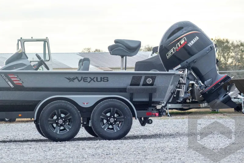 Slide: The Image of 2026 Vexus AVX 1980 boat with Yamaha motor on a trailer, parked outdoors. - 16