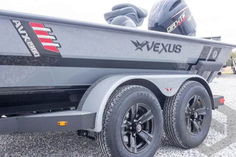 Slide: The Image of 2026 Vexus AVX 1980 boat on trailer, featuring sleek design and dual wheels. - 26