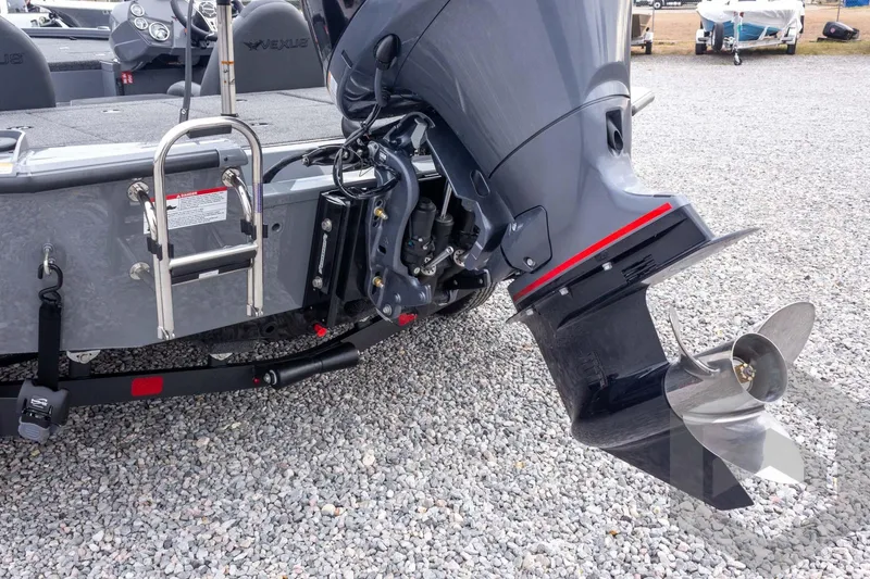 Slide: The Image of 2026 Vexus AVX 1980 boat with outboard motor and ladder on gravel surface. - 31