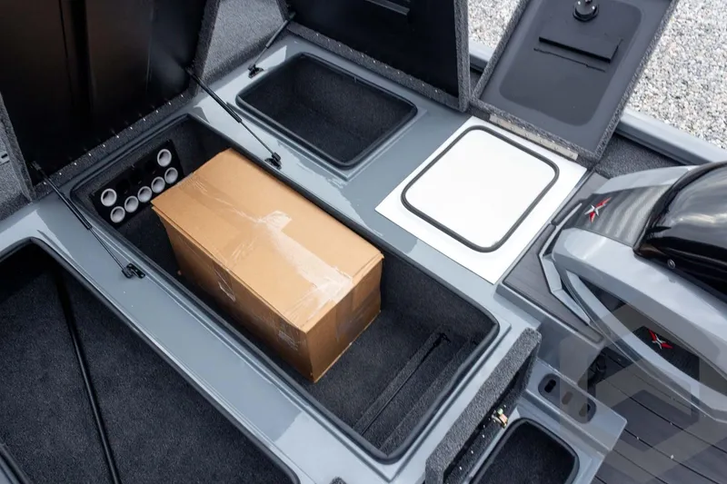 Slide: The Image of 2026 Vexus AVX 1980 boat storage compartments with a cardboard box inside. - 45