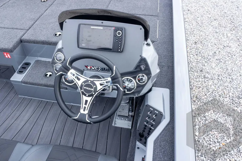 Slide: The Image of 2026 Vexus AVX 1980 boat dashboard with steering wheel and electronic controls. - 57