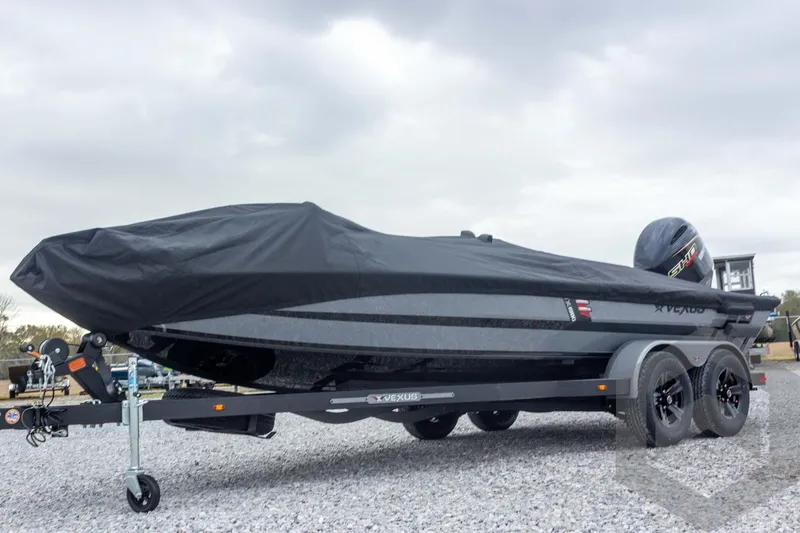 Slide: The Image of 2026 Vexus AVX 1980 boat covered on a trailer, parked on gravel. - 69