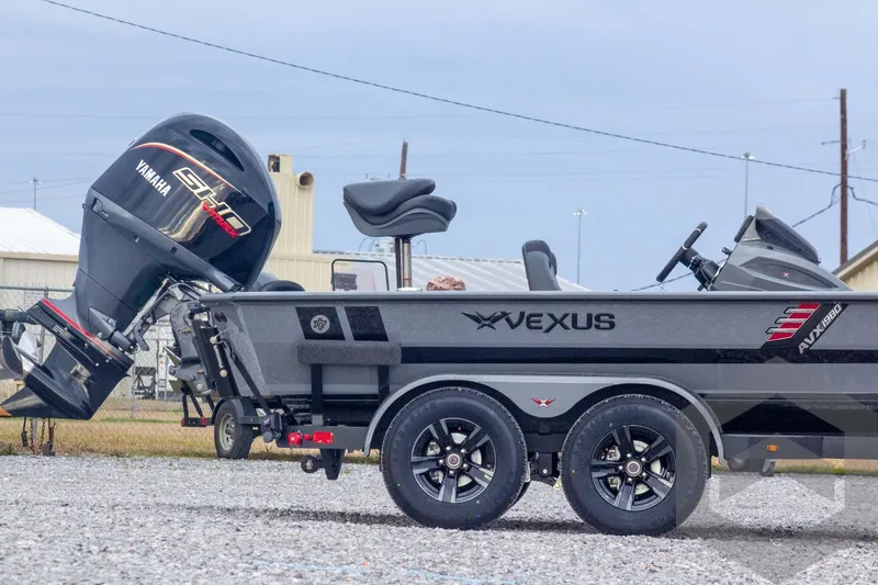 Slide: The Image of 2026 Vexus AVX 1980 boat with Yamaha engine, parked on gravel, side view. - 8