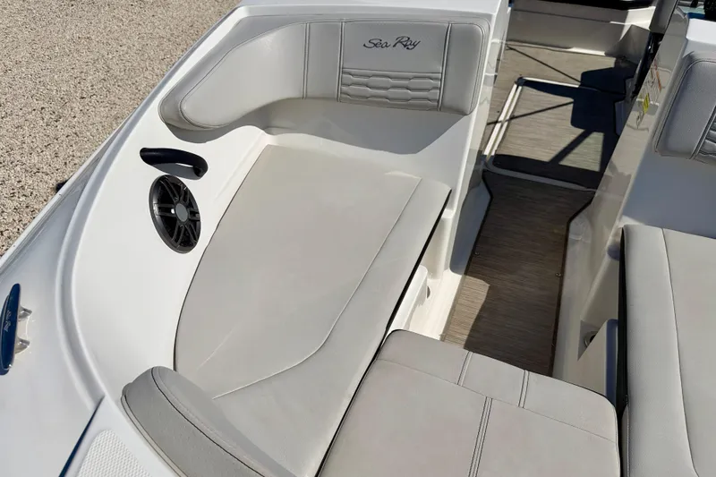 Slide: The Image of 2023 Sea Ray SPX 210 Outboard interior with gray seating and speaker detail. - 10