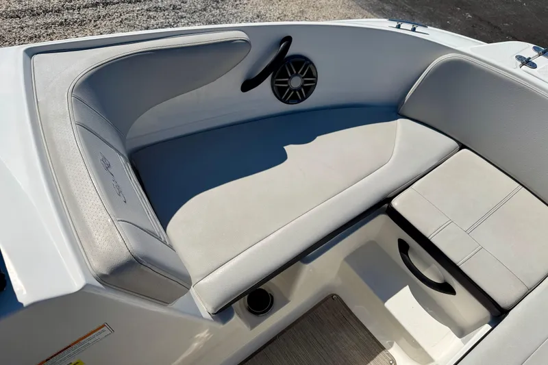 Slide: The Image of 2023 Sea Ray SPX 210 Outboard boat interior with cushioned seating and speaker. - 12