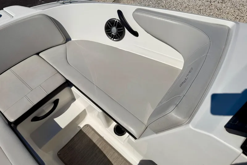 Slide: The Image of 2023 Sea Ray SPX 210 Outboard boat interior with gray seating and speaker detail. - 13
