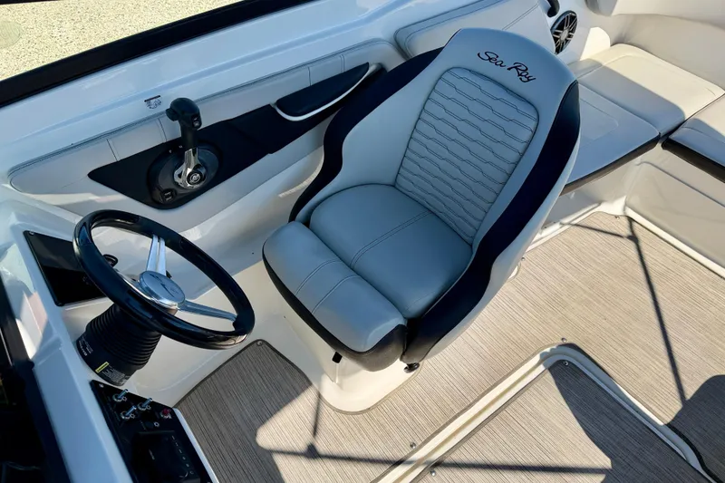 Slide: The Image of 2023 Sea Ray SPX 210 Outboard boat interior with steering wheel and captain's seat. - 16