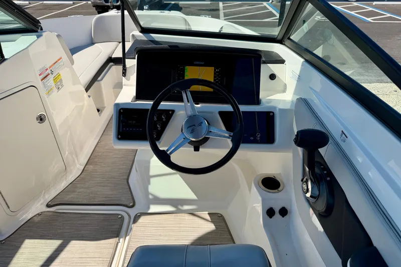 Slide: The Image of 2023 Sea Ray SPX 210 Outboard boat cockpit with steering wheel and control panel. - 17