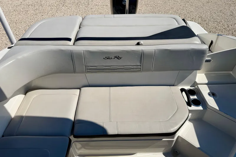 Slide: The Image of 2023 Sea Ray SPX 210 Outboard boat interior with cushioned seating and cup holders. - 22
