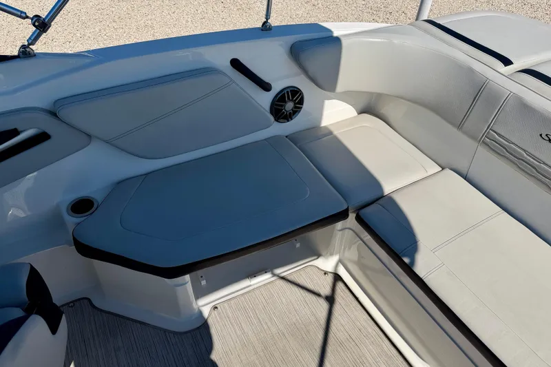 Slide: The Image of 2023 Sea Ray SPX 210 Outboard boat interior with cushioned seating and speaker. - 25