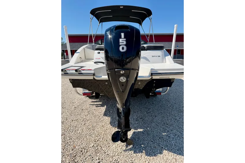 Slide: The Image of 2023 Sea Ray SPX 210 Outboard boat with 150 HP engine, parked on gravel. - 29